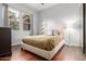 Bedroom with wood floors, large window, and neutral-colored walls and bedding at 1407 E Artemis Trl, San Tan Valley, AZ 85140
