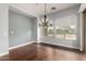 Dining room features a chandelier, natural lighting, and hardwood floors at 1407 E Artemis Trl, San Tan Valley, AZ 85140