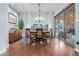 Dining room with wood floors, a stylish chandelier, and views of the backyard patio at 1407 E Artemis Trl, San Tan Valley, AZ 85140