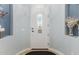 Bright entryway with an arched white door, elegant decor, and calming blue-gray walls at 1407 E Artemis Trl, San Tan Valley, AZ 85140