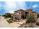 Inviting single-story home with desert landscaping and tiled walkway at 1407 E Artemis Trl, San Tan Valley, AZ 85140