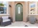 Inviting front entryway with an olive-green door, neutral walls, cushioned seat and bright light fixture at 1407 E Artemis Trl, San Tan Valley, AZ 85140