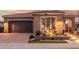 Charming home showcasing a brick driveway, desert landscaping, and a spacious two-car garage at 1407 E Artemis Trl, San Tan Valley, AZ 85140