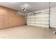 Spacious garage featuring custom cabinetry, epoxy flooring, and overhead lighting at 1407 E Artemis Trl, San Tan Valley, AZ 85140