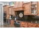 Gourmet kitchen featuring wood cabinetry, state of the art appliances and tiled backsplash at 1407 E Artemis Trl, San Tan Valley, AZ 85140
