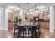 Spacious kitchen with a center island, wooden cabinets, modern appliances, and stylish pendant lights at 1407 E Artemis Trl, San Tan Valley, AZ 85140