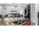 Kitchen island with granite countertops overlooking the living room; features pendant lighting and modern fixtures at 1407 E Artemis Trl, San Tan Valley, AZ 85140
