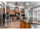 Well-equipped kitchen with a dark granite island, stainless steel appliances, and wood cabinetry at 1407 E Artemis Trl, San Tan Valley, AZ 85140