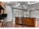 Kitchen island features a granite countertop, stainless steel appliances, and dark wood cabinetry at 1407 E Artemis Trl, San Tan Valley, AZ 85140