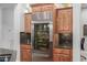 Gourmet kitchen featuring a large stainless steel refrigerator, custom cabinets, and granite countertops at 1407 E Artemis Trl, San Tan Valley, AZ 85140