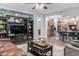 Open-concept living room featuring a large entertainment center and views of the kitchen and other living spaces at 1407 E Artemis Trl, San Tan Valley, AZ 85140