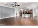 Open-concept living room flows into kitchen with hardwood floors and a ceiling fan at 1407 E Artemis Trl, San Tan Valley, AZ 85140