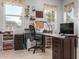 Bright office space with large windows, desk, storage and neutral wall paint at 1407 E Artemis Trl, San Tan Valley, AZ 85140