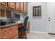 Home office with built-in desk, wooden cabinets, and comfortable office chair at 1407 E Artemis Trl, San Tan Valley, AZ 85140