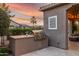 Built-in outdoor kitchen with stainless steel grill, countertop, and decorative wall art for stylish entertaining at 1407 E Artemis Trl, San Tan Valley, AZ 85140