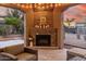 Covered patio featuring a cozy brick fireplace with a seating area at 1407 E Artemis Trl, San Tan Valley, AZ 85140