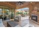 Covered patio features a cozy seating area and brick fireplace with outdoor access at 1407 E Artemis Trl, San Tan Valley, AZ 85140