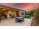 Outdoor patio space with dining table, manicured lawn and string lighting at 1407 E Artemis Trl, San Tan Valley, AZ 85140