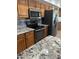 Kitchen featuring modern appliances including oven, microwave, and refrigerator with granite counters at 14710 W Antelope Dr, Sun City West, AZ 85375