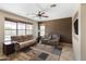 Spacious living room with plush couches, ceiling fan, and natural light at 16055 W Anasazi St, Goodyear, AZ 85338