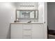 Bathroom vanity featuring modern mirror, white cabinets, and designer fixtures at 16402 N 31St St # 102, Phoenix, AZ 85032