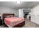 Bedroom with tile floors, grey walls, closet, and a comfortable bed at 16402 N 31St St # 102, Phoenix, AZ 85032