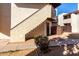 Exterior view of a two-story unit with a private fenced in area, stairs, and painted stucco walls at 16402 N 31St St # 102, Phoenix, AZ 85032