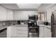Well-lit kitchen with stainless steel appliances, white cabinets, gray countertops, and a window at 16402 N 31St St # 102, Phoenix, AZ 85032