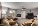 Cozy living room showcasing a fireplace, tile floors, comfortable seating, and access to the outdoor patio at 16402 N 31St St # 102, Phoenix, AZ 85032