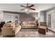 Bright living room featuring comfortable seating, ceiling fan, and a seamless transition to the outdoor space at 16402 N 31St St # 102, Phoenix, AZ 85032