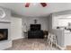 Spacious living room featuring a fireplace, tile flooring, modern decor, and bar stool seating at the kitchen counter at 16402 N 31St St # 102, Phoenix, AZ 85032