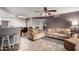 Inviting living room featuring tile floors, comfortable couches, ceiling fan, and seamless flow to the dining area at 16402 N 31St St # 102, Phoenix, AZ 85032