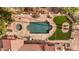 An aerial top down view of the backyard pool and spa, patio, and artificial turf at 16522 E Glenbrook Blvd, Fountain Hills, AZ 85268