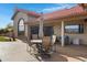 A covered back patio with a dining set, lounge chairs, and mountain views at 16522 E Glenbrook Blvd, Fountain Hills, AZ 85268