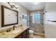 Bathroom featuring granite vanity top, frameless shower, and a glass block window at 16522 E Glenbrook Blvd, Fountain Hills, AZ 85268