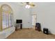 Bedroom with a ceiling fan, carpet flooring, and a large arched window with shutters at 16522 E Glenbrook Blvd, Fountain Hills, AZ 85268