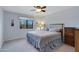 A standard bedroom features a large bed, window, ceiling fan, and carpeted floors at 16522 E Glenbrook Blvd, Fountain Hills, AZ 85268