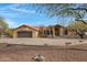 Charming home featuring a tile roof, desert landscaping, and a spacious three car driveway at 16522 E Glenbrook Blvd, Fountain Hills, AZ 85268