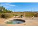 Inviting hot tub featuring a stone surround and picturesque mountain views in the backyard at 16522 E Glenbrook Blvd, Fountain Hills, AZ 85268