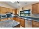 Well-appointed kitchen with granite countertops, a garden window over the sink, and stainless steel appliances at 16522 E Glenbrook Blvd, Fountain Hills, AZ 85268