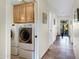 Convenient laundry room and hallway, including oak cabinetry and outdoor access at 16522 E Glenbrook Blvd, Fountain Hills, AZ 85268