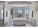 A luxurious bathroom suite featuring a soaking tub and picture windows with desert views at 16522 E Glenbrook Blvd, Fountain Hills, AZ 85268