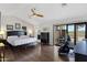 A cozy main bedroom features wood floors, a ceiling fan, ensuite access, and outdoor patio at 16522 E Glenbrook Blvd, Fountain Hills, AZ 85268