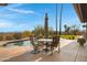 Backyard pool featuring palm trees, a stone patio, and an outdoor dining area at 16522 E Glenbrook Blvd, Fountain Hills, AZ 85268