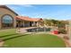 Gorgeous pool and patio area featuring low-maintenance artificial turf at 16522 E Glenbrook Blvd, Fountain Hills, AZ 85268