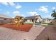 Backyard featuring playground, grassy area, patio, and shed at 17201 N Chance Dr, Surprise, AZ 85374