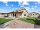 Backyard featuring synthetic lawn, rock landscaping, a shed and covered patio at 17201 N Chance Dr, Surprise, AZ 85374