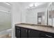 Bathroom featuring a vanity, granite countertop, and combination tub and shower at 17201 N Chance Dr, Surprise, AZ 85374
