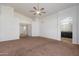 A bedroom features a ceiling fan, a large interior hallway, and an en-suite bathroom at 17201 N Chance Dr, Surprise, AZ 85374