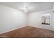 Bedroom features neutral carpet, bright window, and decorative ceiling light at 17201 N Chance Dr, Surprise, AZ 85374